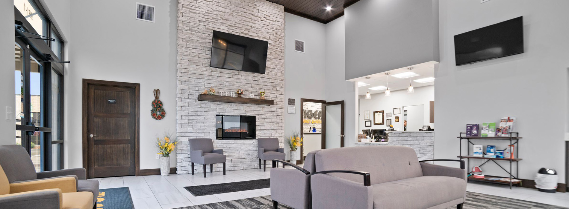The image shows a modern dental clinic interior with various pieces of equipment, including a dental chair and an X-ray machine.