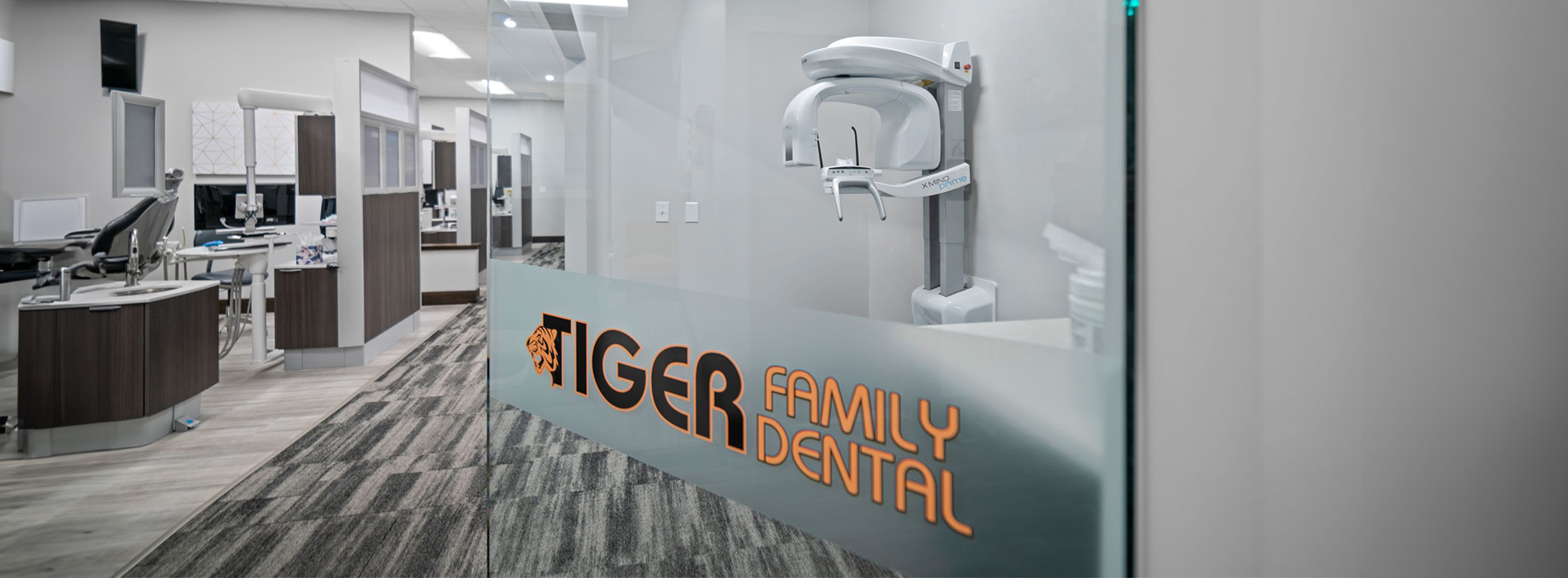 The image shows an interior space with a sign that reads TIGER FAMILY DENTAL.