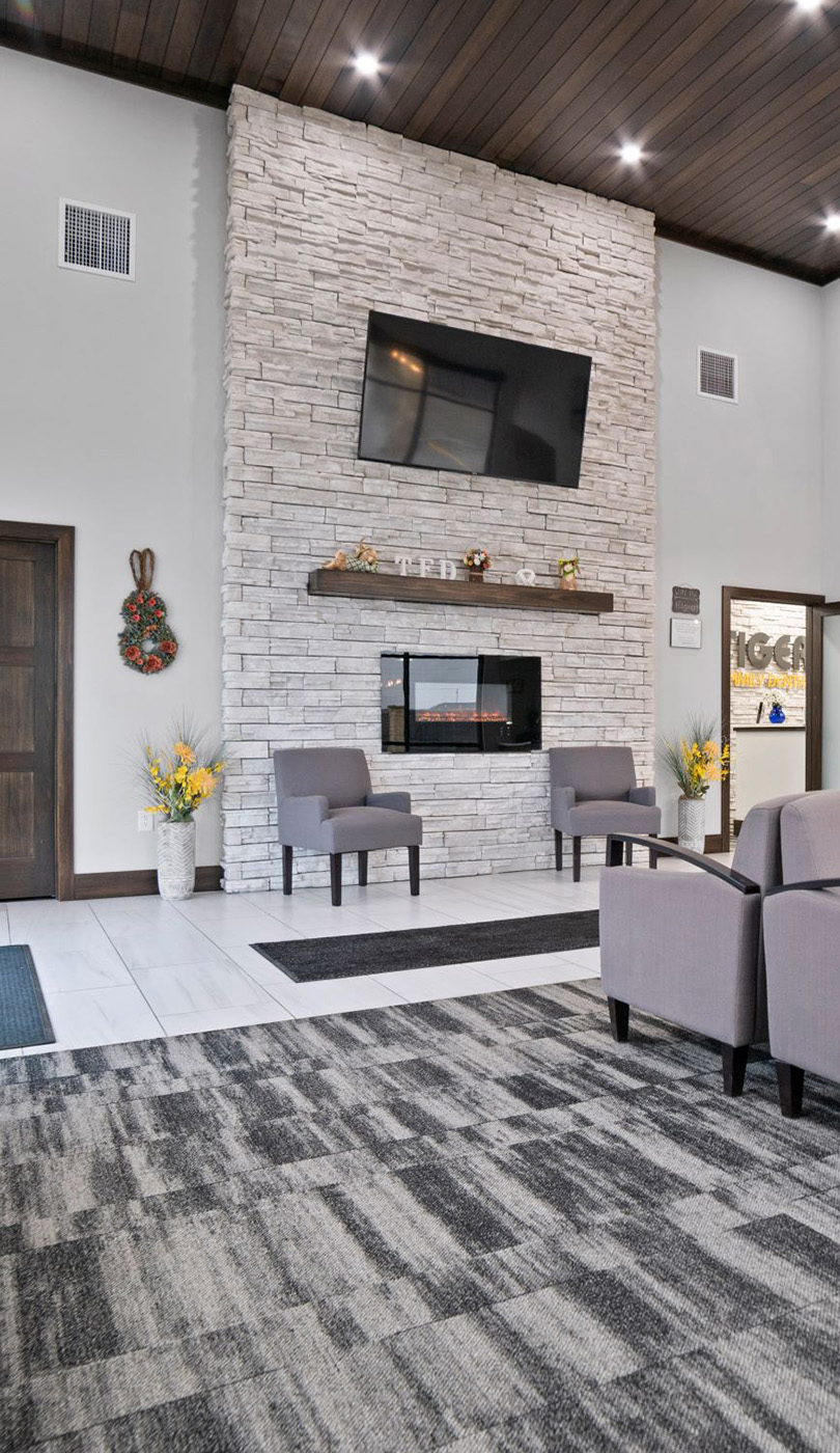 The image shows a modern dental or medical office interior with a dental chair, equipment, and a clean, professional environment.