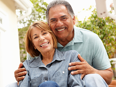 The image shows two adults, an older woman and an older man, posing closely together with smiles on their faces. They appear to be a couple enjoying each other s company.
